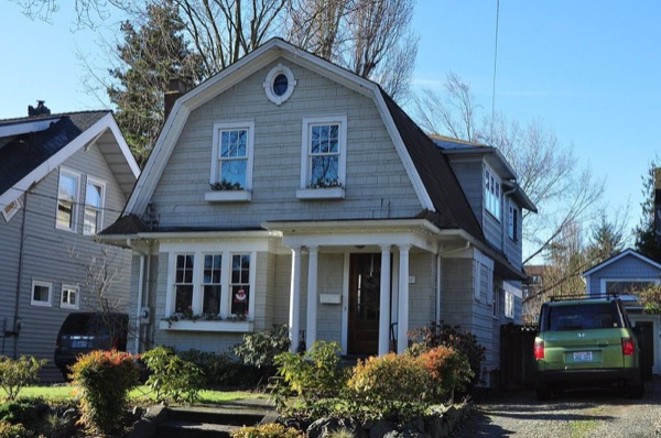A gambrel-roofed house in Seattle's Wallingford neighborhood, the kind of single-family home this kit is built for.