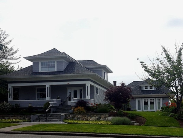 A Craftsman-style Seattle house with a converted garage in the backyard used as a small cottage.