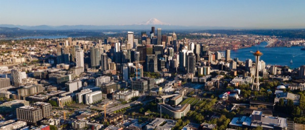 A drone view over Seattle's residential neighborhoods and streets, showing the kind of lots where a pre-approved or custom DADU would be permitted.